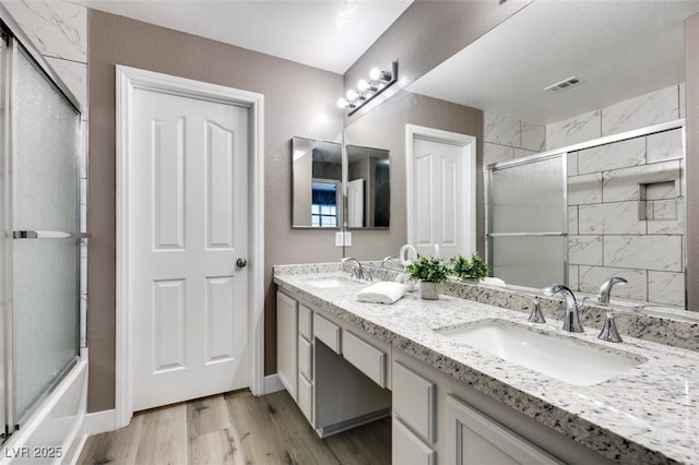 507 Satin Saddle Pl, Henderson, NV 89052 - full bathroom featuring double vanity, wood finished floors, and enclosed tub / shower combo