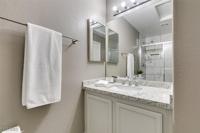 507 Satin Saddle Pl, Henderson, NV 89052 - bathroom with a stall shower, vanity, and a textured wall