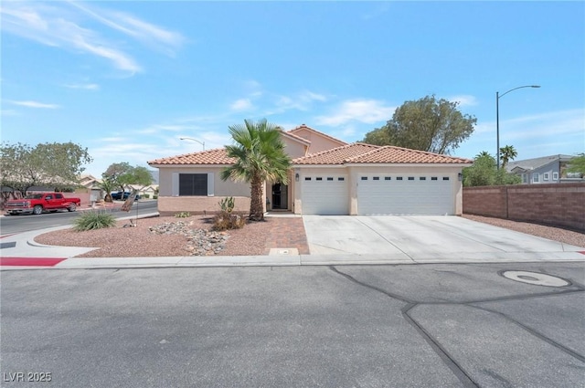 2640 Torch Ave, North Las Vegas, NV 89081 - mediterranean / spanish-style home featuring a garage, concrete driveway, stucco siding, and a tile roof