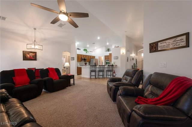 2640 Torch Ave, North Las Vegas, NV 89081 - living room with light carpet, arched walkways, a ceiling fan, and lofted ceiling