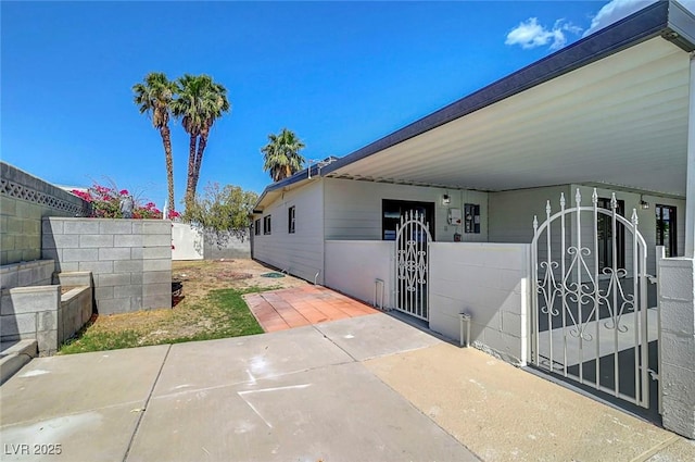 4807 Sacks Dr, Las Vegas, NV 89122 - view of side of property with a gate and a carport