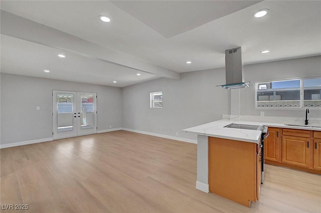 4807 Sacks Dr, Las Vegas, NV 89122 - kitchen with island exhaust hood, light wood-style flooring, recessed lighting, open floor plan, and brown cabinets