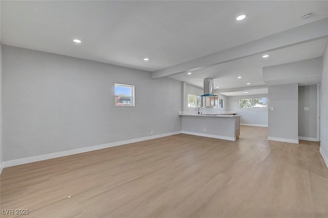 4807 Sacks Dr, Las Vegas, NV 89122 - unfurnished living room with light wood-type flooring, recessed lighting, and beam ceiling