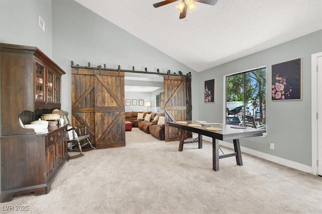5008 Donnie Ave, Las Vegas, NV 89130 - office area featuring a barn door, light colored carpet, ceiling fan, and vaulted ceiling