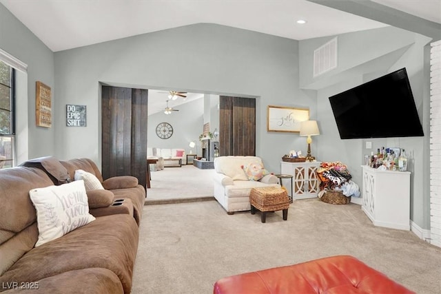 5008 Donnie Ave, Las Vegas, NV 89130 - living area featuring carpet floors, vaulted ceiling, a ceiling fan, and a fireplace