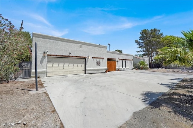 5008 Donnie Ave, Las Vegas, NV 89130 - view of front facade with a garage, stucco siding, and driveway