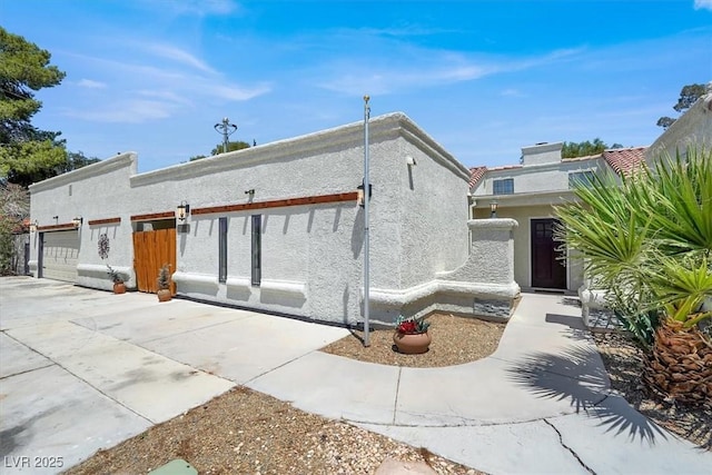 5008 Donnie Ave, Las Vegas, NV 89130 - view of front of house with an attached garage, stucco siding, and concrete driveway