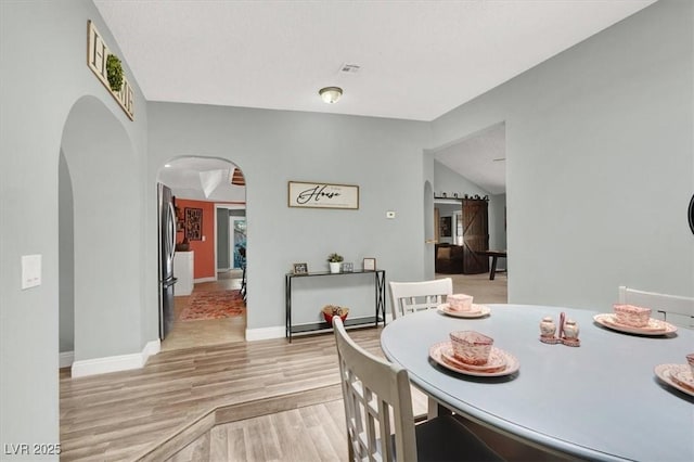 5008 Donnie Ave, Las Vegas, NV 89130 - dining space featuring arched walkways and light wood finished floors
