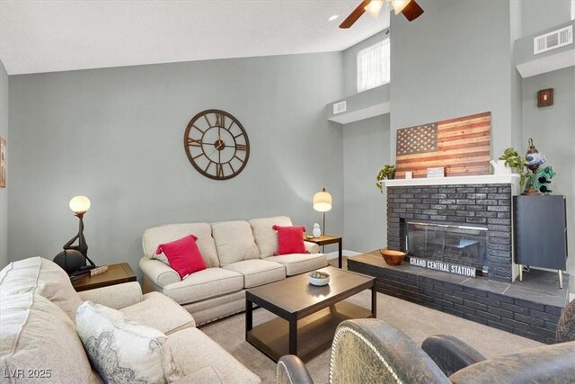 5008 Donnie Ave, Las Vegas, NV 89130 - living room with ceiling fan, a fireplace, carpet, and a towering ceiling