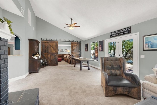 5008 Donnie Ave, Las Vegas, NV 89130 - living room with a barn door, ceiling fan, carpet flooring, high vaulted ceiling, and french doors