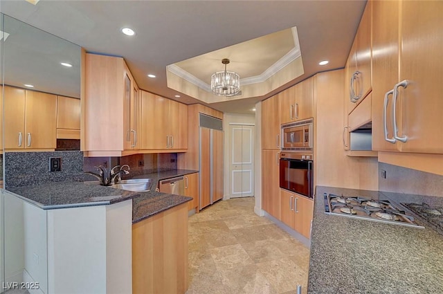 2877 Paradise Rd Unit 2105, Las Vegas, NV 89109 - kitchen with built in appliances, crown molding, a raised ceiling, dark stone counters, and a chandelier
