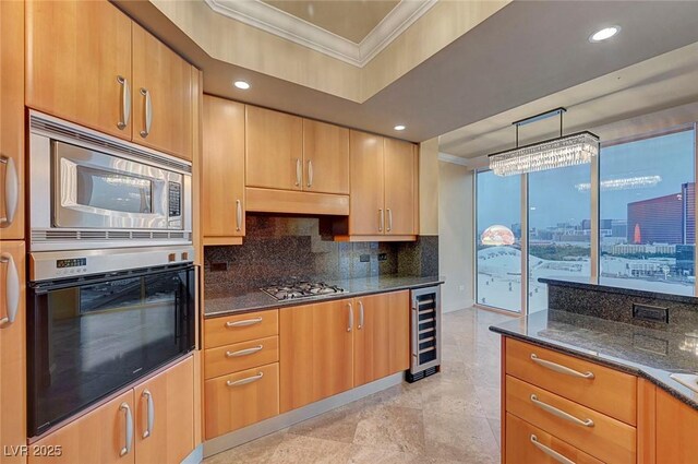 2877 Paradise Rd Unit 2105, Las Vegas, NV 89109 - kitchen with appliances with stainless steel finishes, crown molding, wine cooler, dark stone countertops, and decorative backsplash