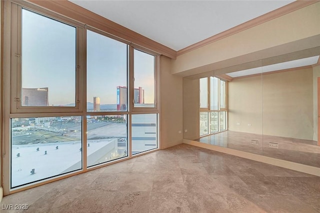 2877 Paradise Rd Unit 2105, Las Vegas, NV 89109 - spare room featuring crown molding and healthy amount of natural light