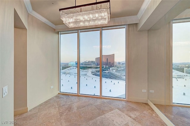 2877 Paradise Rd Unit 2105, Las Vegas, NV 89109 - spare room with ornamental molding, a chandelier, a city view, and floor to ceiling windows