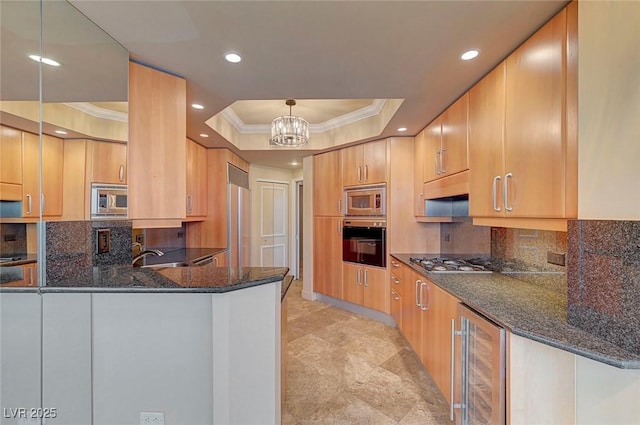 2877 Paradise Rd Unit 2105, Las Vegas, NV 89109 - kitchen featuring appliances with stainless steel finishes, wine cooler, a tray ceiling, ornamental molding, and dark stone counters