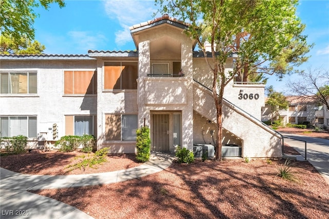 3060 Tarpon Dr Unit 104, Las Vegas, NV 89120 - view of front of house featuring stucco siding and a tiled roof