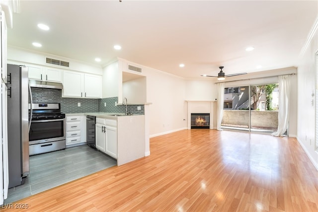 3060 Tarpon Dr Unit 104, Las Vegas, NV 89120 - kitchen featuring stainless steel appliances, under cabinet range hood, open floor plan, ceiling fan, and ornamental molding