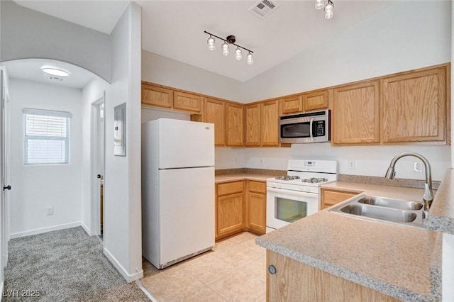 5521 Jackpot Winner Ln Unit 101, Las Vegas, NV 89122 - kitchen featuring white appliances, arched walkways, light countertops, light tile patterned flooring, and lofted ceiling