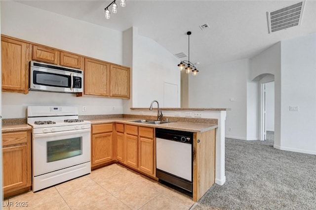 5521 Jackpot Winner Ln Unit 101, Las Vegas, NV 89122 - kitchen with white appliances, arched walkways, vaulted ceiling, a peninsula, and light countertops