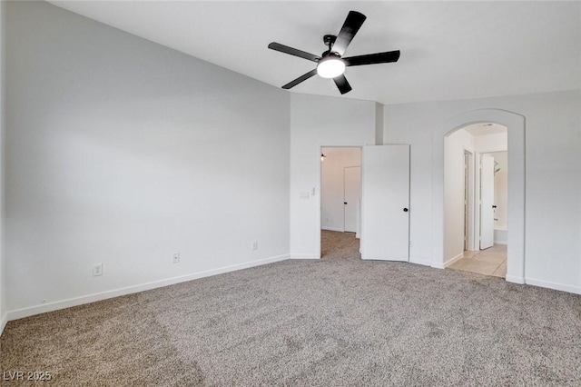 5521 Jackpot Winner Ln Unit 101, Las Vegas, NV 89122 - unfurnished bedroom featuring light carpet, arched walkways, and ceiling fan