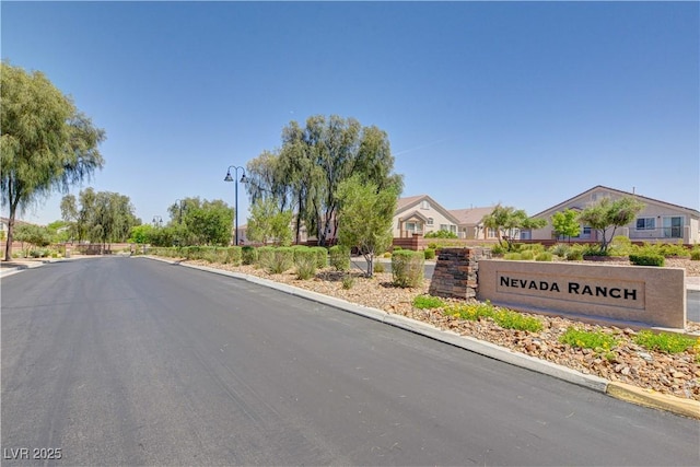 5521 Jackpot Winner Ln Unit 101, Las Vegas, NV 89122 - view of asphalt street featuring street lights, curbs, and a residential view