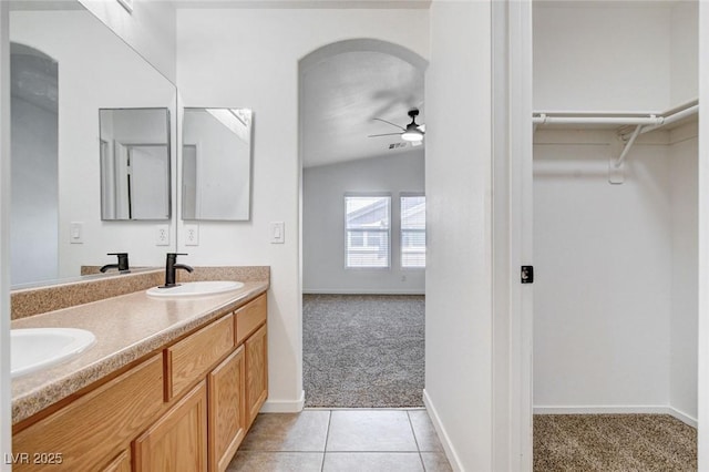 5521 Jackpot Winner Ln Unit 101, Las Vegas, NV 89122 - bathroom featuring a ceiling fan, double vanity, lofted ceiling, a spacious closet, and tile patterned flooring