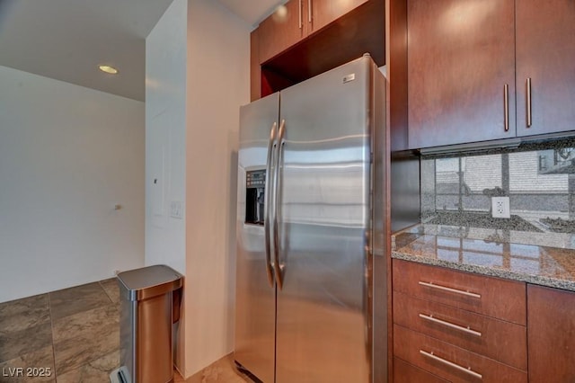 353 E Bonneville Ave Unit 313, Las Vegas, NV 89101 - kitchen with stainless steel refrigerator with ice dispenser, light stone countertops, and brown cabinetry