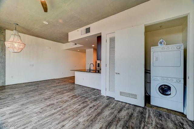 353 E Bonneville Ave Unit 313, Las Vegas, NV 89101 - laundry area with stacked washer / drying machine and wood finished floors