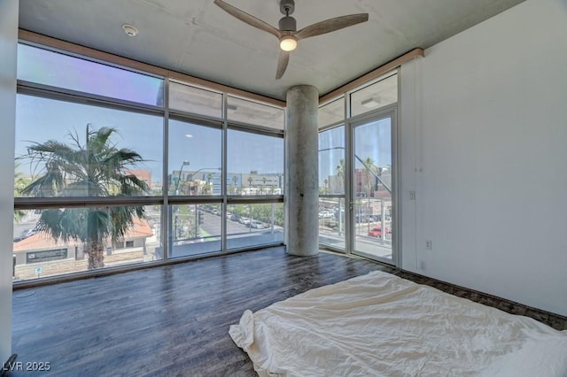 353 E Bonneville Ave Unit 313, Las Vegas, NV 89101 - bedroom with a view of city, access to outside, wood finished floors, multiple windows, and floor to ceiling windows