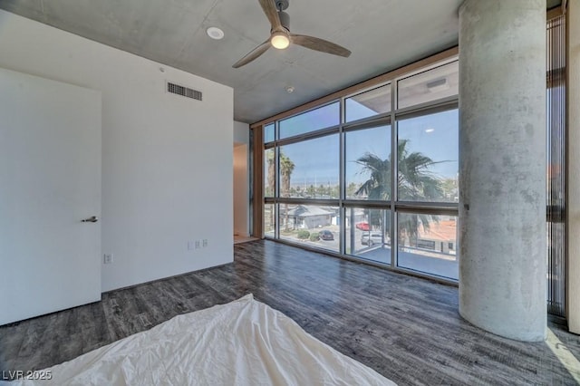 353 E Bonneville Ave Unit 313, Las Vegas, NV 89101 - unfurnished bedroom featuring floor to ceiling windows and wood finished floors