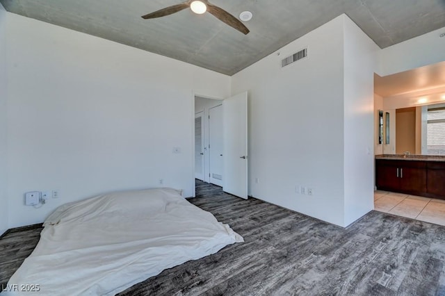 353 E Bonneville Ave Unit 313, Las Vegas, NV 89101 - bedroom featuring wood finished floors, ensuite bath, and ceiling fan