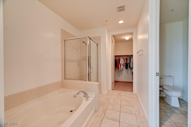 353 E Bonneville Ave Unit 313, Las Vegas, NV 89101 - bathroom with a garden tub, a stall shower, tile patterned flooring, a walk in closet, and recessed lighting