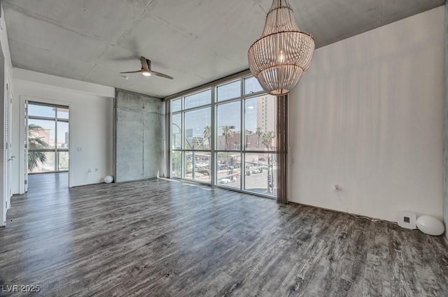 353 E Bonneville Ave Unit 313, Las Vegas, NV 89101 - empty room featuring wood finished floors, a ceiling fan, a chandelier, and a view of city