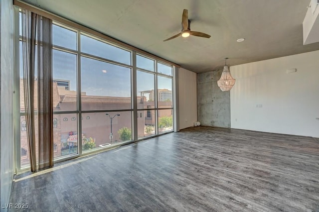 353 E Bonneville Ave Unit 313, Las Vegas, NV 89101 - empty room featuring a ceiling fan, wood finished floors, and expansive windows