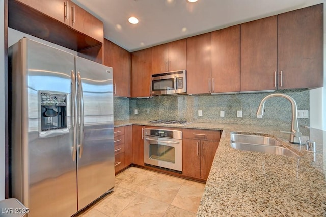 353 E Bonneville Ave Unit 313, Las Vegas, NV 89101 - kitchen with stainless steel appliances, light stone countertops, tasteful backsplash, recessed lighting, and brown cabinetry