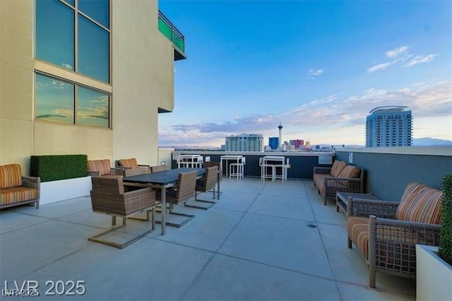 353 E Bonneville Ave Unit 313, Las Vegas, NV 89101 - view of patio with an outdoor living space, outdoor dining area, and a city view