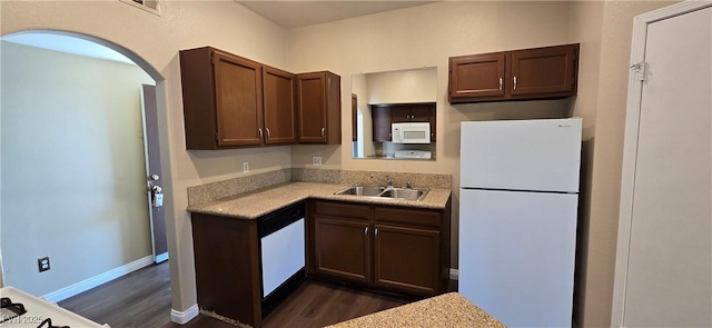 9000 Las Vegas Blvd Unit 1015, Las Vegas, NV 89123 - kitchen with white appliances, dark wood finished floors, light countertops, and arched walkways