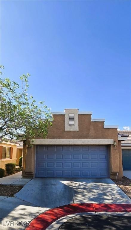 5045 Bayberry Crest St, North Las Vegas, NV 89031 - view of front of home with an attached garage, stucco siding, and concrete driveway