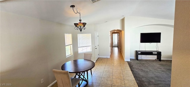 5045 Bayberry Crest St, North Las Vegas, NV 89031 - carpeted dining room featuring arched walkways, a chandelier, and tile patterned floors