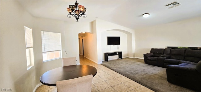 5045 Bayberry Crest St, North Las Vegas, NV 89031 - living area with arched walkways, light carpet, light tile patterned floors, and a chandelier