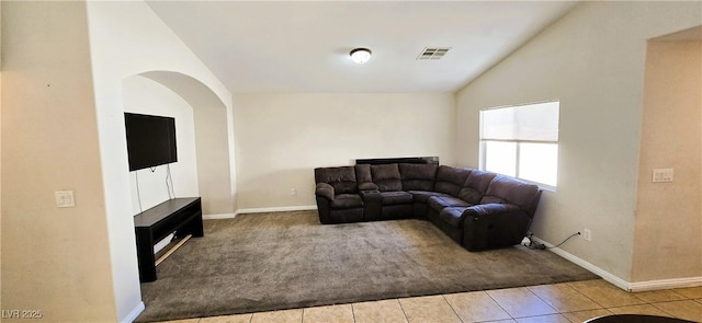 5045 Bayberry Crest St, North Las Vegas, NV 89031 - carpeted living room with vaulted ceiling, tile patterned flooring, and arched walkways