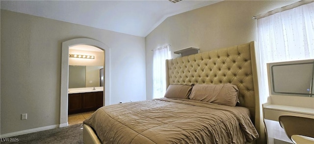 5045 Bayberry Crest St, North Las Vegas, NV 89031 - carpeted bedroom with arched walkways, lofted ceiling, and ensuite bathroom