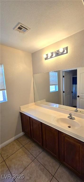 5045 Bayberry Crest St, North Las Vegas, NV 89031 - bathroom with vanity, tile patterned flooring, and a textured ceiling