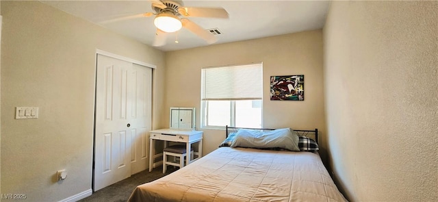 5045 Bayberry Crest St, North Las Vegas, NV 89031 - bedroom with a closet, dark colored carpet, a textured wall, and a ceiling fan