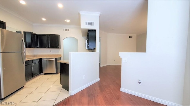 9000 Las Vegas Blvd Unit 1074, Las Vegas, NV 89123 - kitchen featuring stainless steel appliances, light countertops, dark cabinets, crown molding, and light wood-style flooring