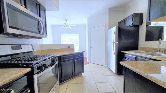 9000 Las Vegas Blvd Unit 1074, Las Vegas, NV 89123 - kitchen with stainless steel appliances, crown molding, light countertops, a ceiling fan, and light tile patterned floors