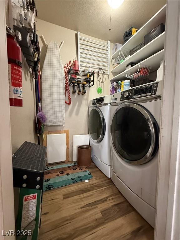 1829 Campton St, Ely, NV 89301 - laundry area featuring independent washer and dryer, wood finished floors, and a textured ceiling