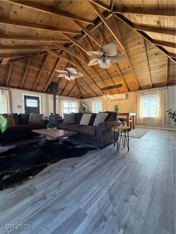 1829 Campton St, Ely, NV 89301 - living room with a wood ceiling with exposed beams, a wall unit AC, a wood stove, wood finished floors, and ceiling fan