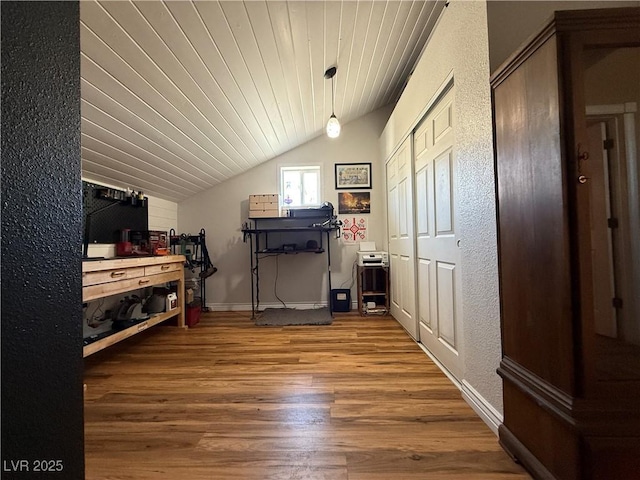 1829 Campton St, Ely, NV 89301 - bedroom featuring vaulted ceiling, wood finished floors, a textured wall, wooden ceiling, and two closets