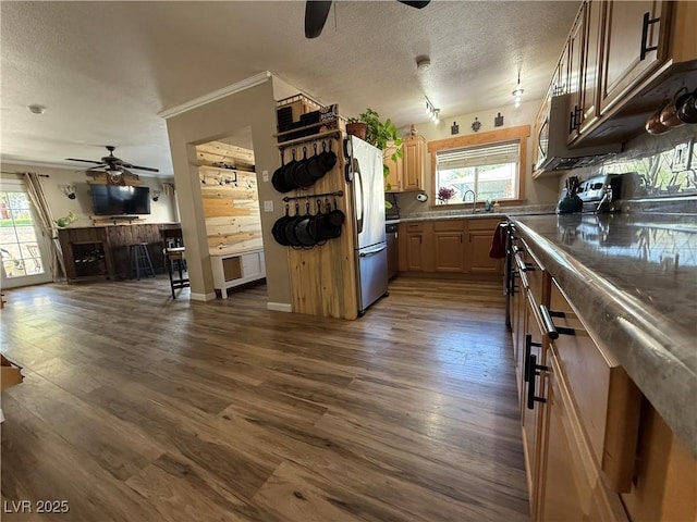 1829 Campton St, Ely, NV 89301 - kitchen featuring a ceiling fan, a textured ceiling, open floor plan, dark wood-style floors, and appliances with stainless steel finishes